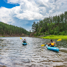 Kayakers in Pactola Lake in the Black Hills National Forest of South Dakota