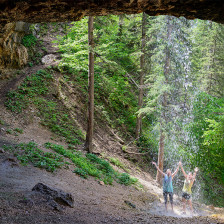 Hikers admiring the waterfall at Community Caves near Spearhead, South Dakota